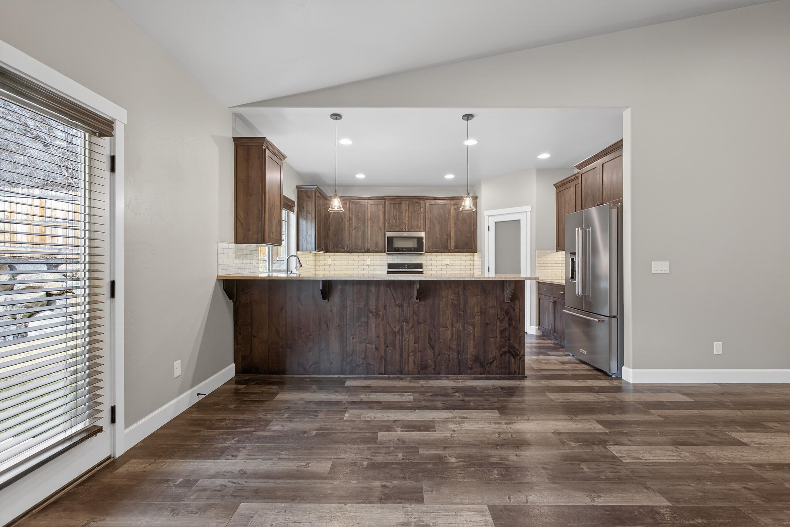 2793 Southwest 33rd Street Redmond, OR 97756 - Photo 9 of 44 a view of kitchen with kitchen island wooden floor and refrigerator