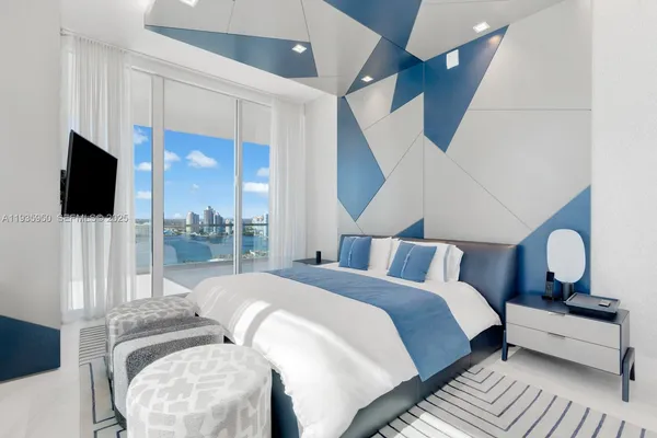 a bedroom with a bed and glass window