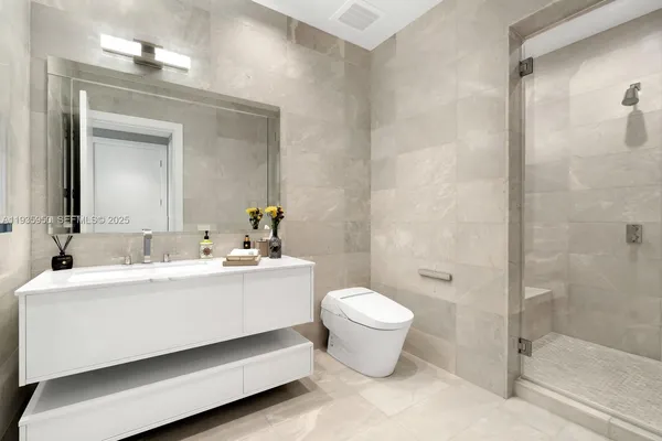 a spacious bedroom with a bed and glass door