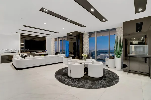 a living room with furniture and flat screen tv