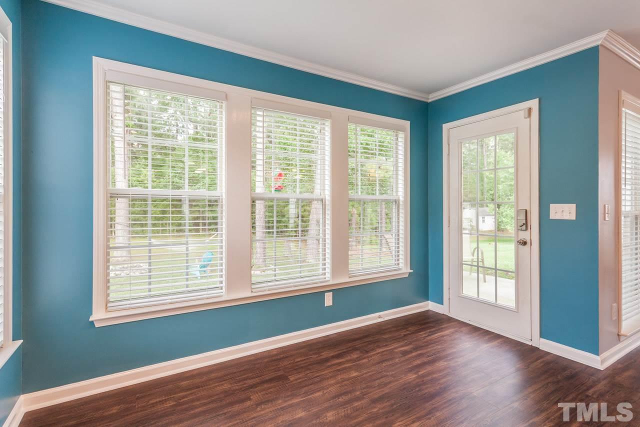 5216 Cardinal Grove Boulevard Raleigh, NC 27616 - Photo 13 of 25 a view of an empty room with wooden floor and a window