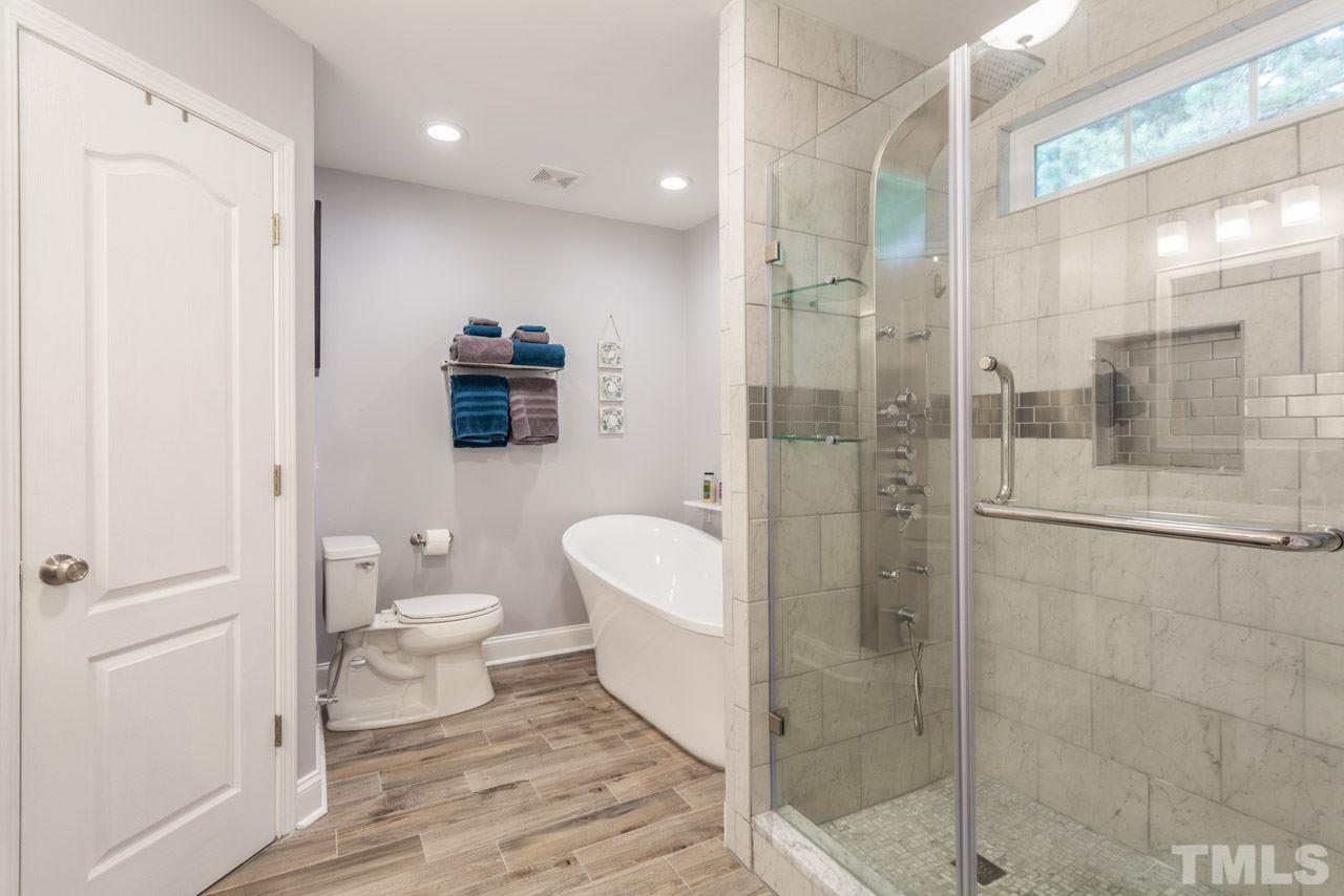 5216 Cardinal Grove Boulevard Raleigh, NC 27616 - Photo 15 of 25 a bathroom with a toilet a sink and shower