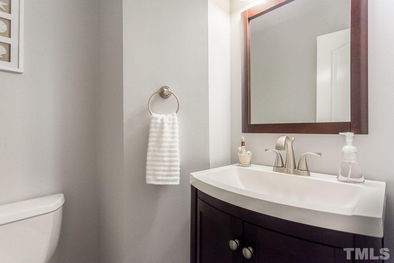 5216 Cardinal Grove Boulevard Raleigh, NC 27616 - Photo 17 of 25 a bathroom with a sink a toilet and a mirror