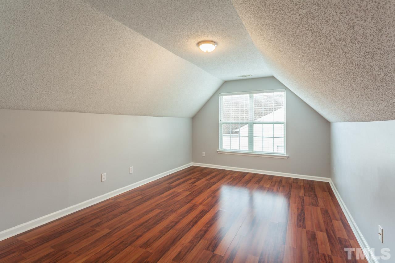 5216 Cardinal Grove Boulevard Raleigh, NC 27616 - Photo 20 of 25 an empty room with wooden floor and windows