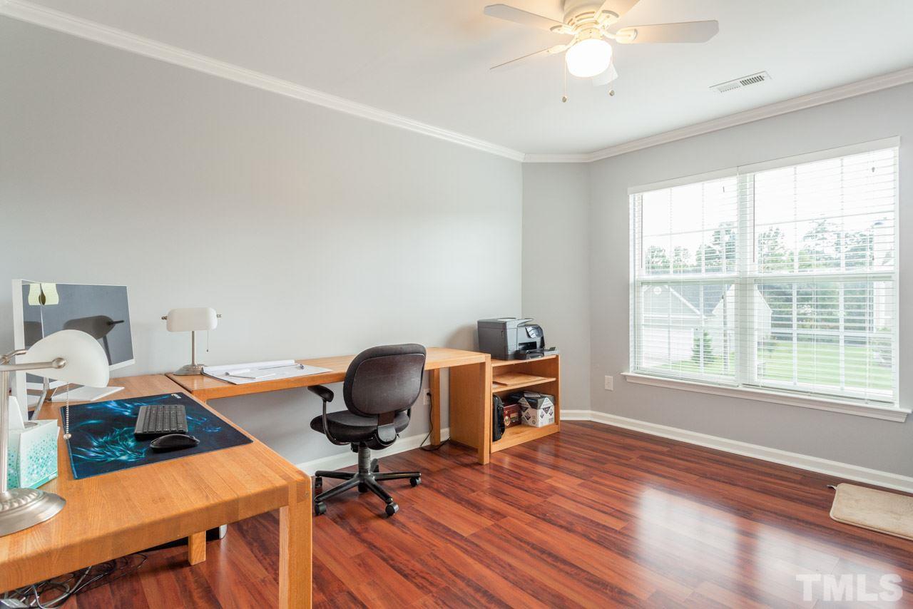 5216 Cardinal Grove Boulevard Raleigh, NC 27616 - Photo 21 of 25 a view of a workspace with furniture and a window