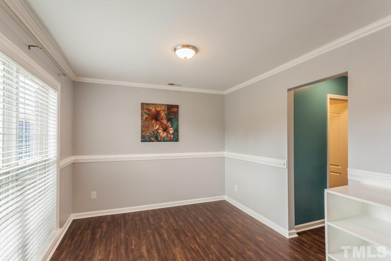 5216 Cardinal Grove Boulevard Raleigh, NC 27616 - Photo 4 of 25 an empty room with wooden floor and windows