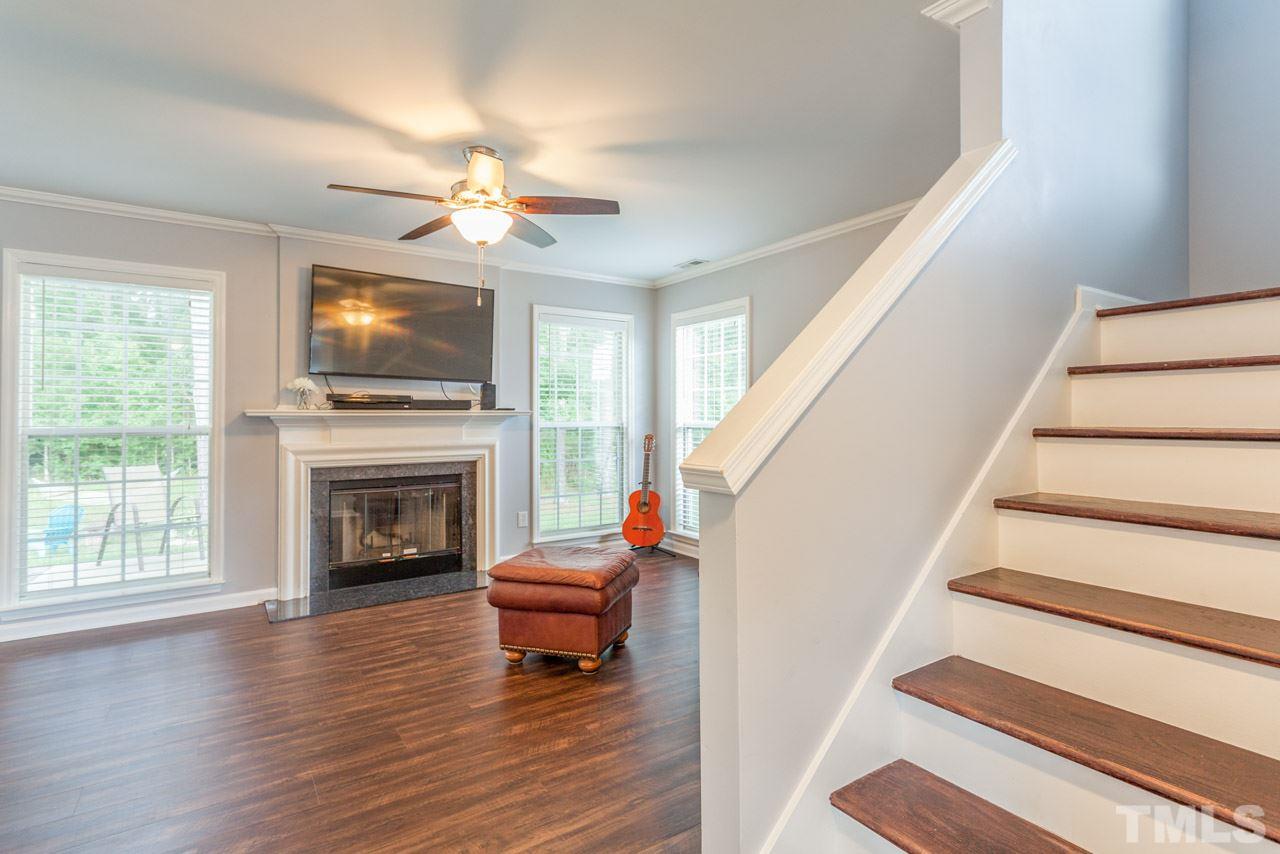 5216 Cardinal Grove Boulevard Raleigh, NC 27616 - Photo 6 of 25 a living room with furniture a fireplace and a flat screen tv