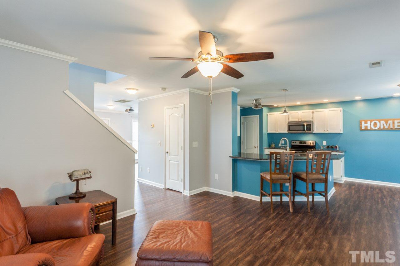 5216 Cardinal Grove Boulevard Raleigh, NC 27616 - Photo 8 of 25 a living room with furniture and a wooden floor