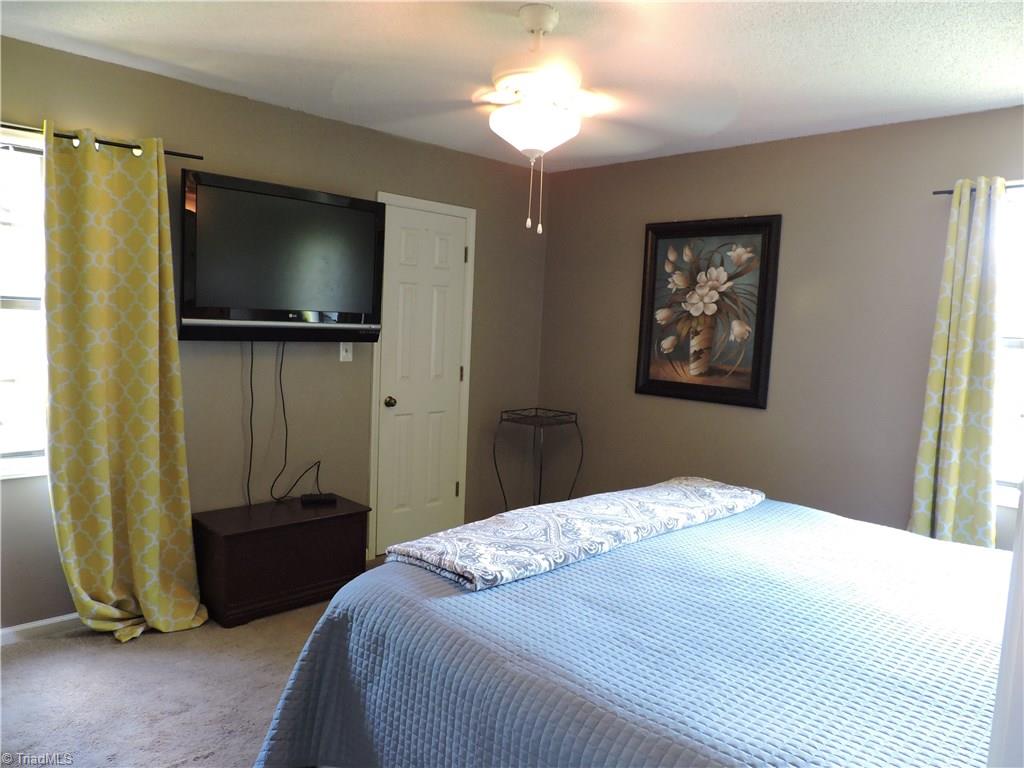 7116 North River Road Oak Ridge, NC 27310 - Photo 14 of 22 Master bedroom with walk-in closet.