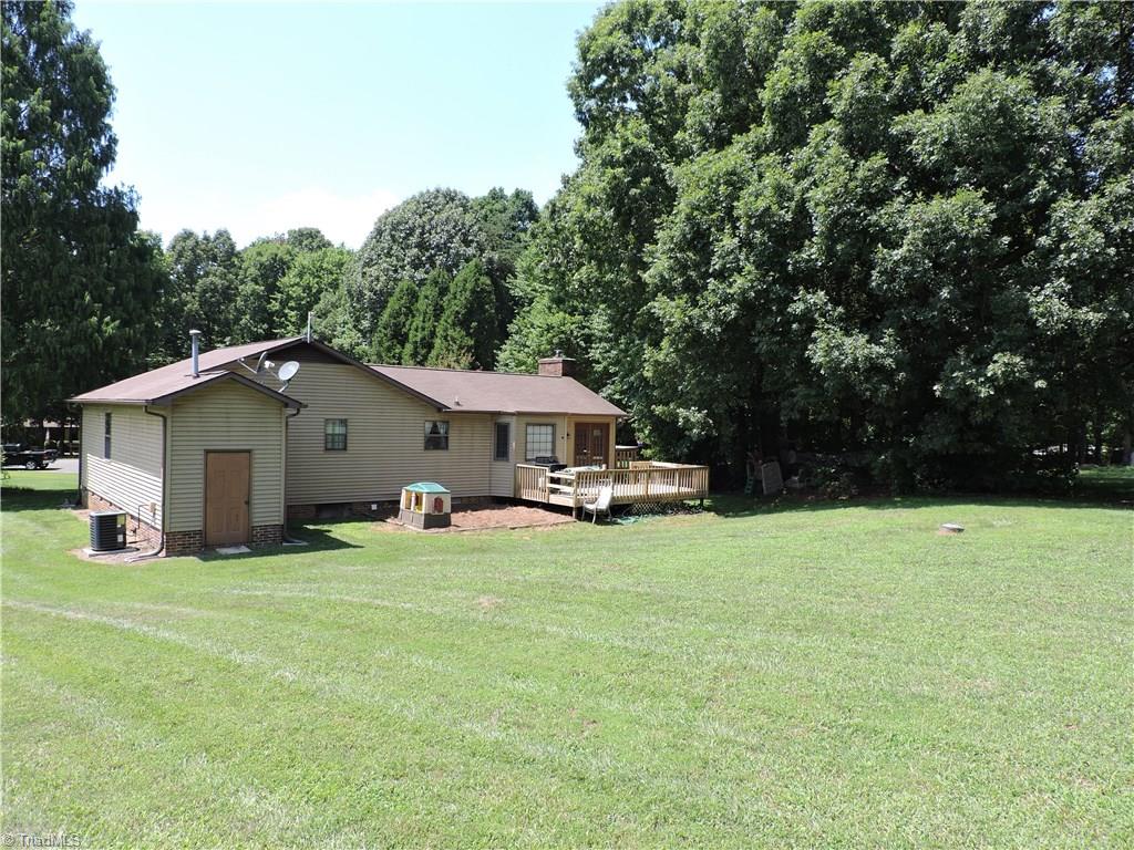 7116 North River Road Oak Ridge, NC 27310 - Photo 20 of 22 Large back yard bordered by impressive stand of trees.