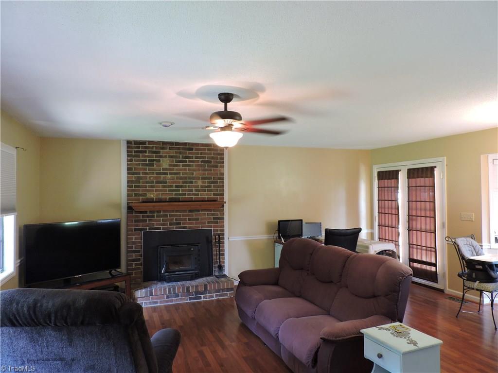 7116 North River Road Oak Ridge, NC 27310 - Photo 3 of 22 Great room combines living area with dining area.