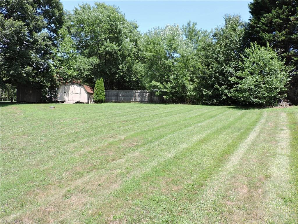 7116 North River Road Oak Ridge, NC 27310 - Photo 22 of 22 Tons of backyard space leads back to the storage shed.