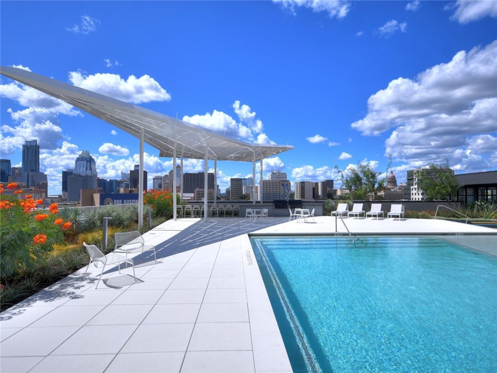a view of a patio with dining table and chairs with plants and a yard