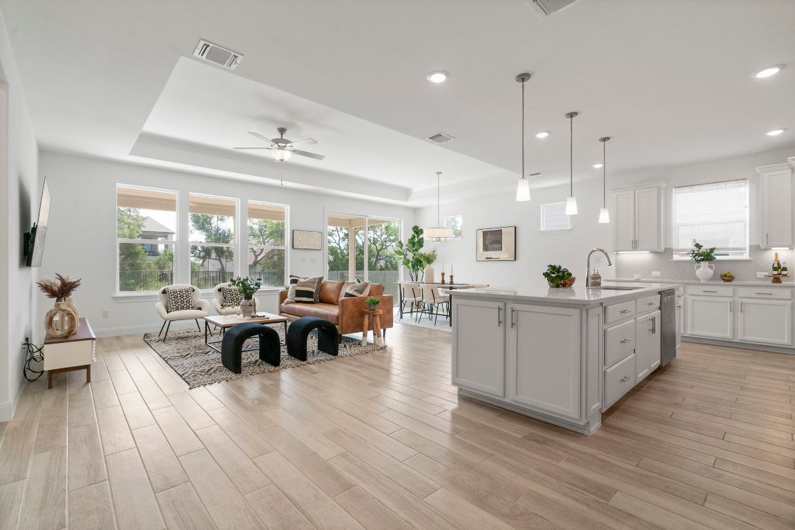 a kitchen with stainless steel appliances granite countertop a stove and a wooden floors