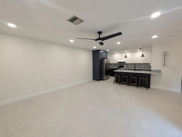a kitchen with a sink a counter space and stainless steel appliances