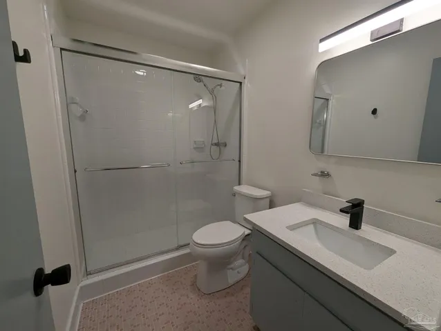 a bathroom with a sink toilet and mirror