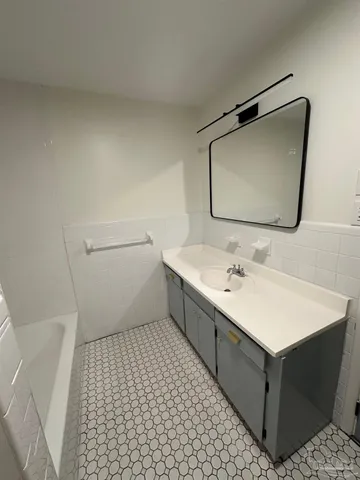 a bathroom with a sink and a bath tub
