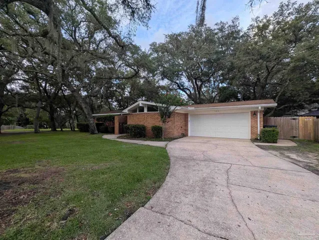 a front view of house with yard and trees