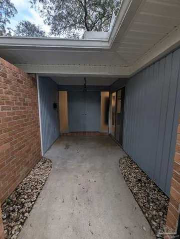 a view of a backyard with large trees and wooden fence