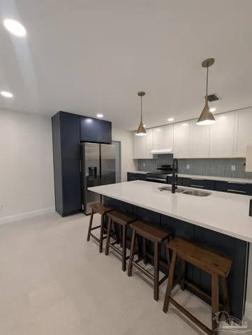 an empty room with furniture and a ceiling fan