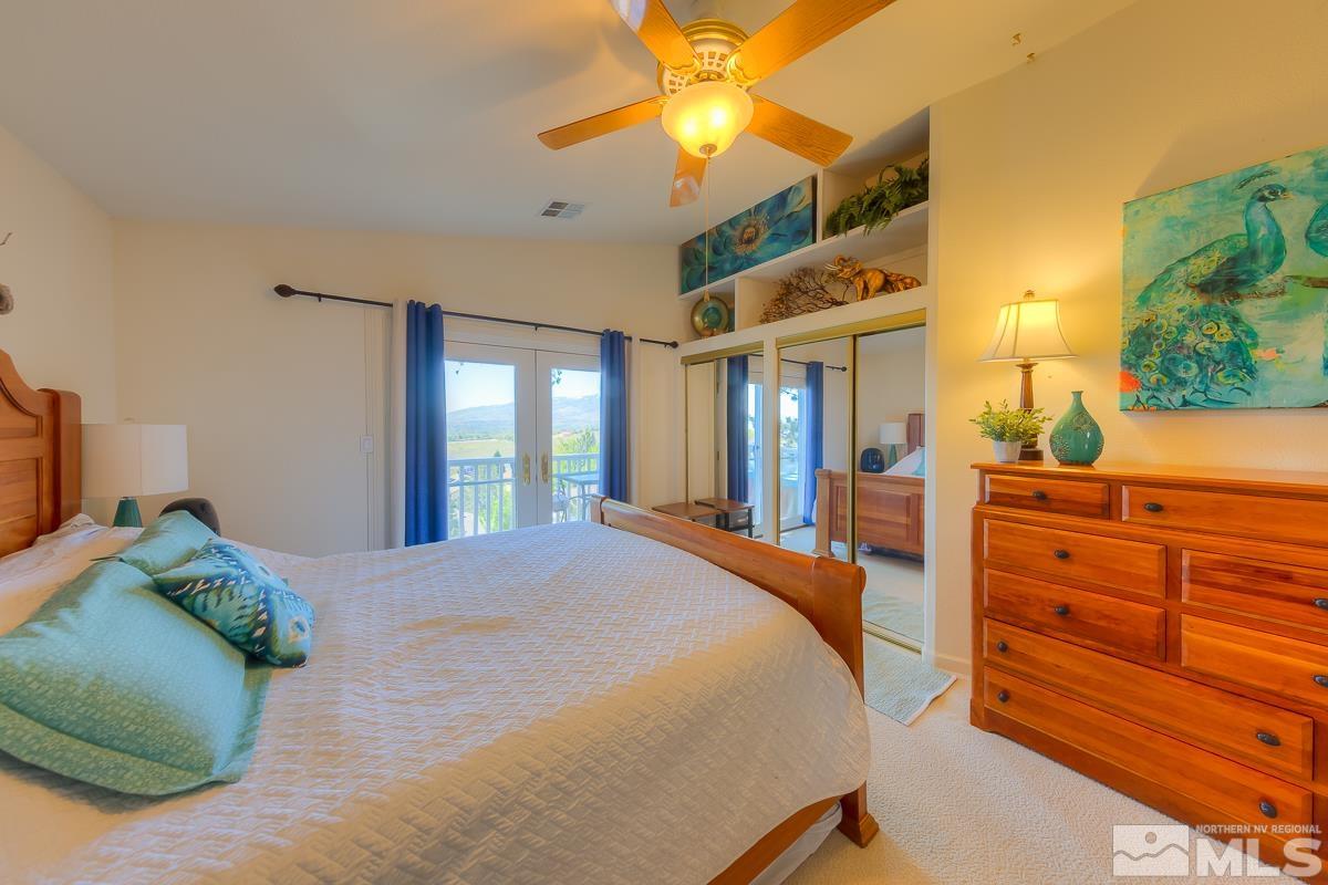 642 Talus Way Reno, NV 89503 - Photo 15 of 40 a bedroom with a bed and a chandelier