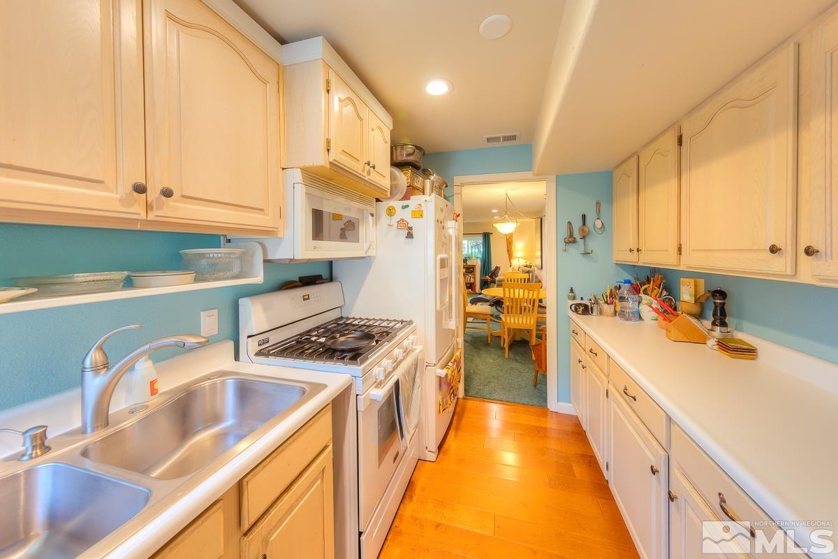 642 Talus Way Reno, NV 89503 - Photo 21 of 40 a kitchen with stainless steel appliances granite countertop a sink and cabinets