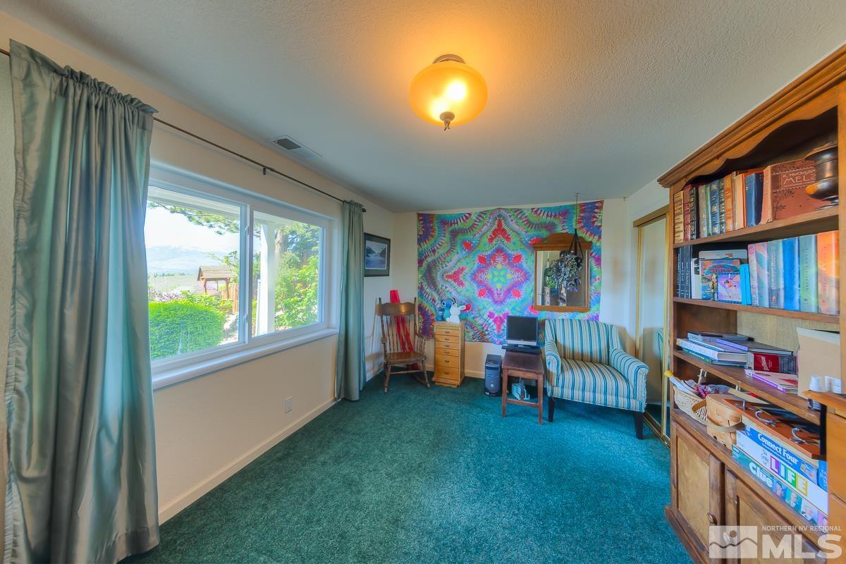 642 Talus Way Reno, NV 89503 - Photo 25 of 40 a living room with lots of furniture and a bookshelf
