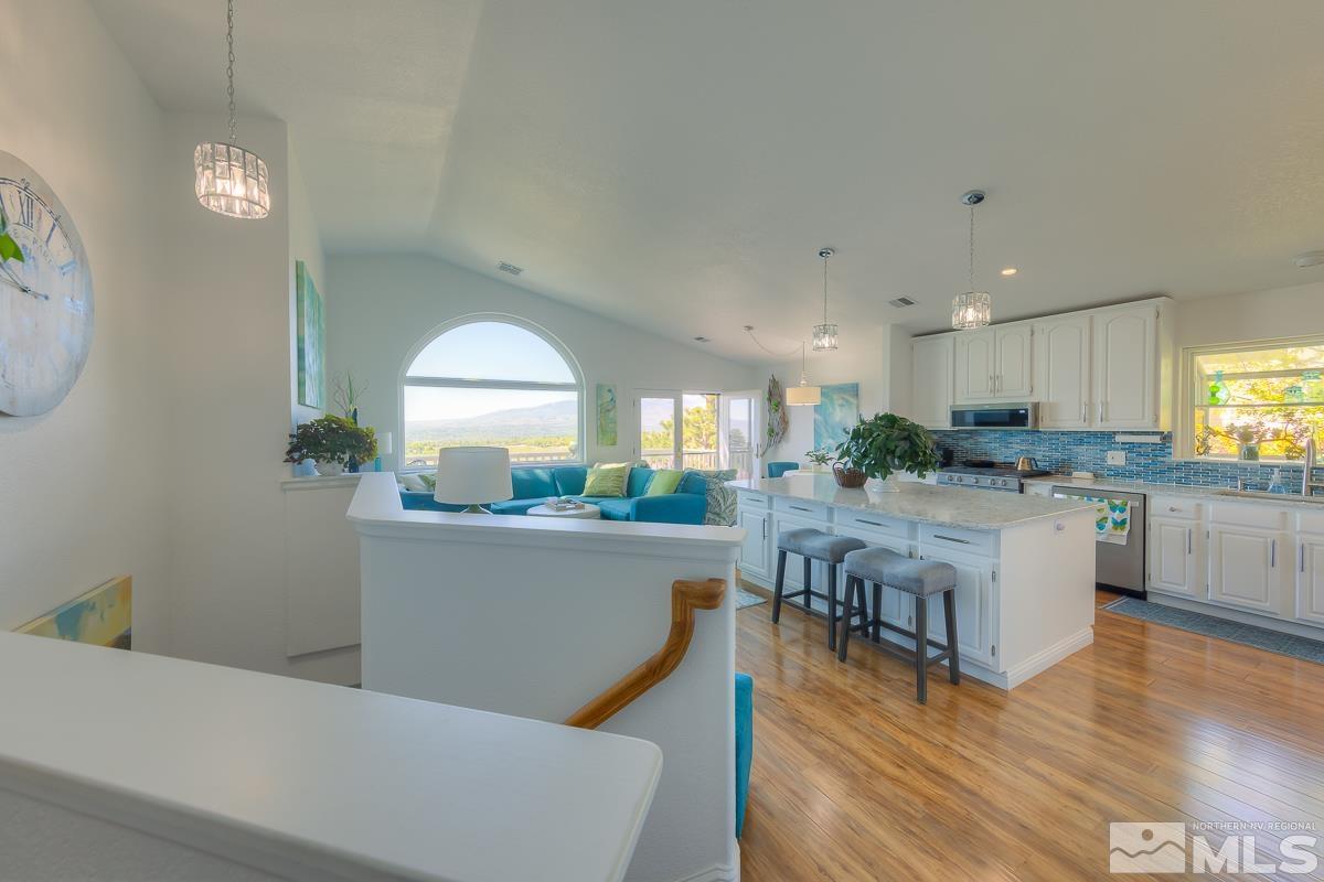 642 Talus Way Reno, NV 89503 - Photo 7 of 40 a living room with stainless steel appliances granite countertop a couch a dining table and chairs