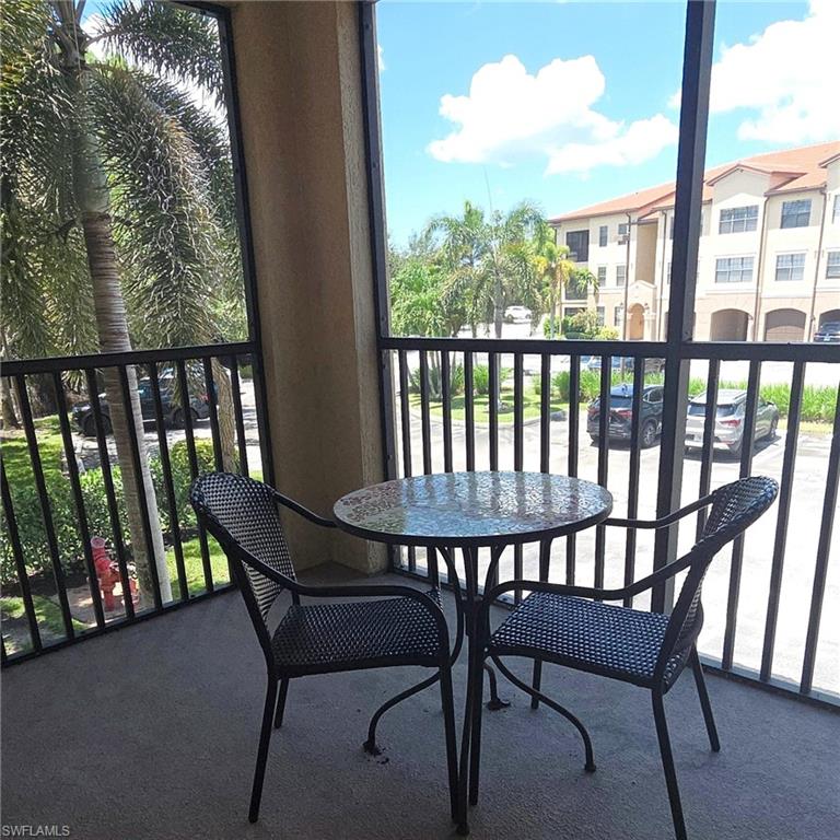 12975 Positano Circle, Unit 207 Naples, FL 34105 - Photo 11 of 24 Balcony featuring a sunroom