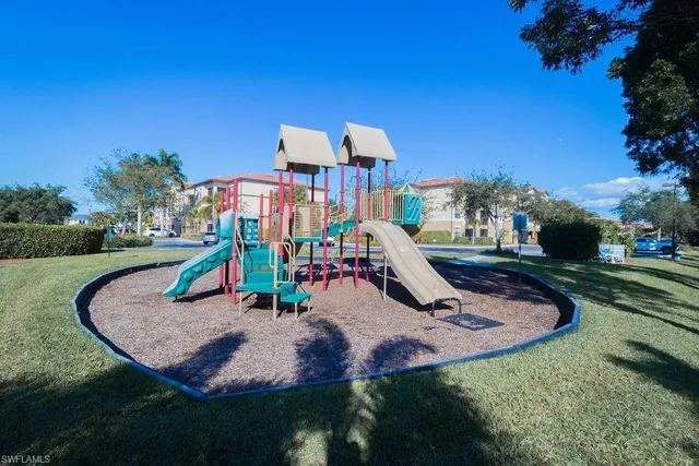a view of outdoor space with playground and green space