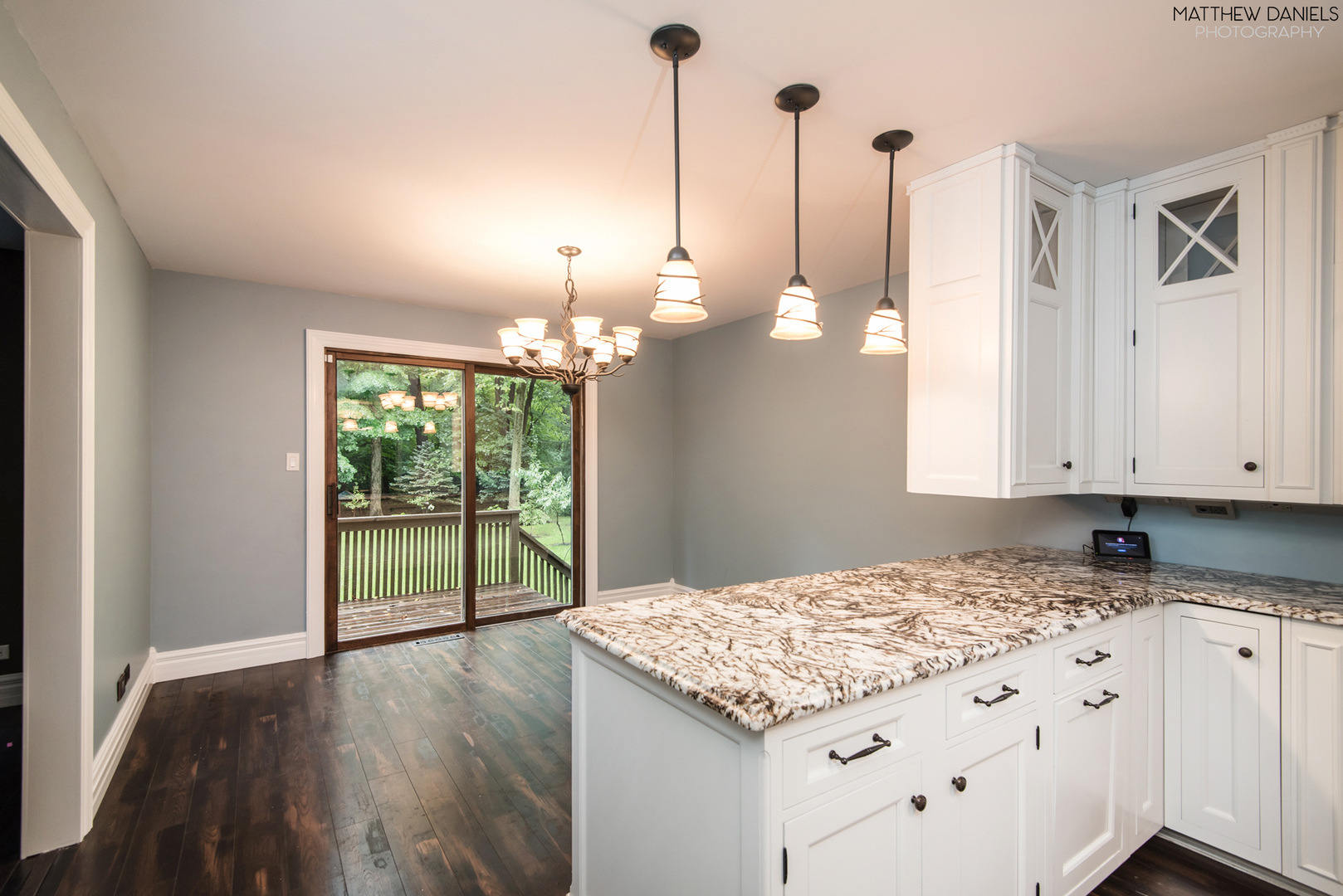 584 Aberdeen Road Frankfort, IL 60423 - Photo 25 of 60 a kitchen with kitchen island granite countertop a stove a chimney a large island with wooden floor and cabinets