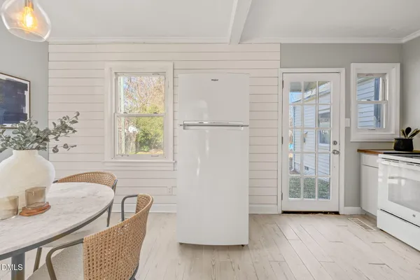 a kitchen with a dining table and chairs
