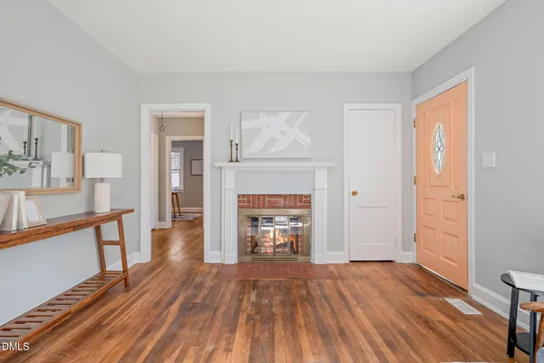 a living room with furniture a fireplace and a table