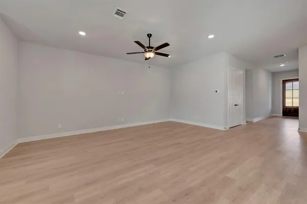 a living room with furniture a ceiling fan and a rug