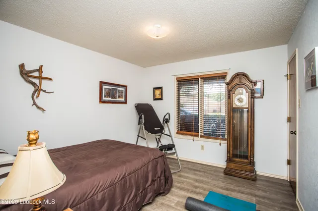 a bedroom with bed and wooden floor