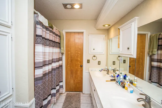 a bathroom with a tub sink and mirror