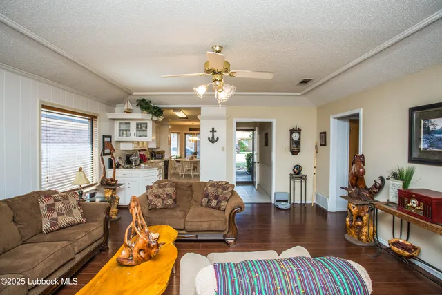 a living room with furniture fireplace and wooden floor