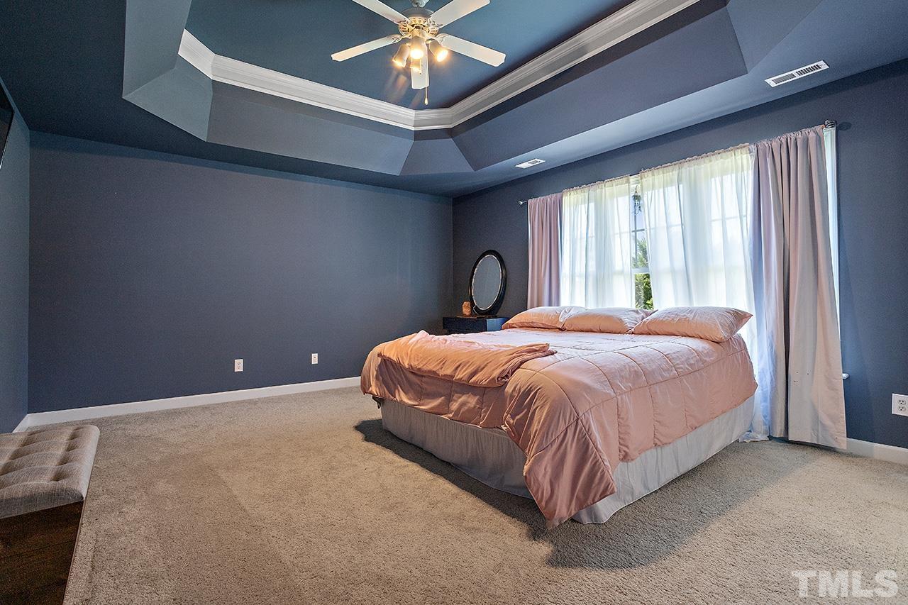 709 Rushing Falls Place Fuquay-Varina, NC 27526 - Photo 14 of 28 a bed sitting in a room next to a window