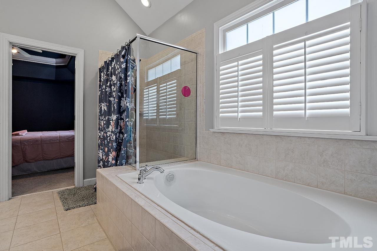 709 Rushing Falls Place Fuquay-Varina, NC 27526 - Photo 17 of 28 a bathroom with a bathtub and a shower