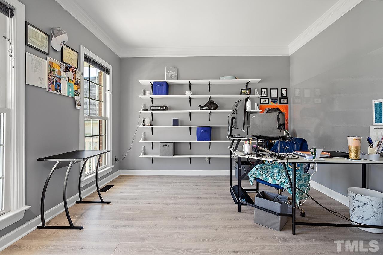 709 Rushing Falls Place Fuquay-Varina, NC 27526 - Photo 6 of 28 a room with lots of wooden furniture and a book shelf