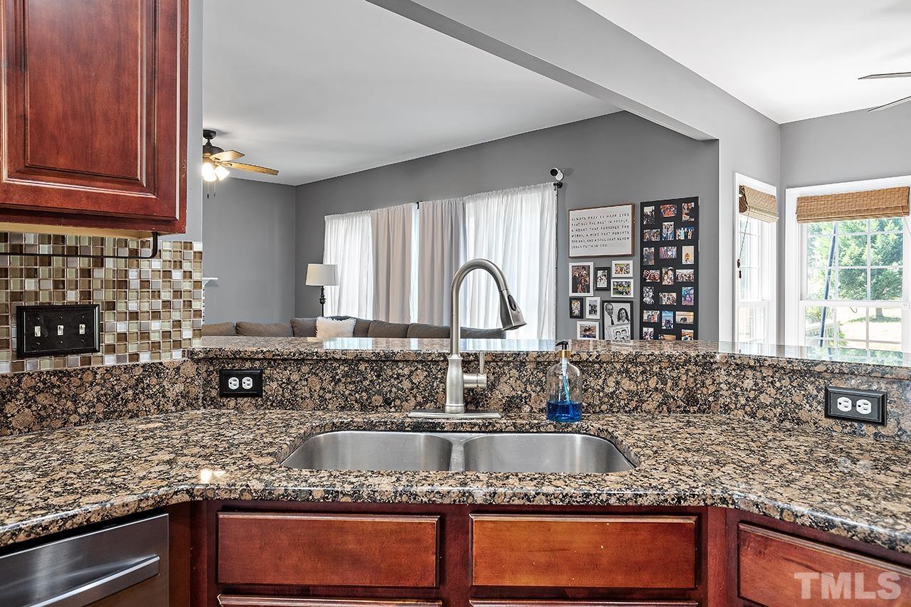 709 Rushing Falls Place Fuquay-Varina, NC 27526 - Photo 10 of 28 a kitchen with granite countertop a sink and a window