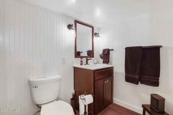 a bathroom with a black and white checkered floor