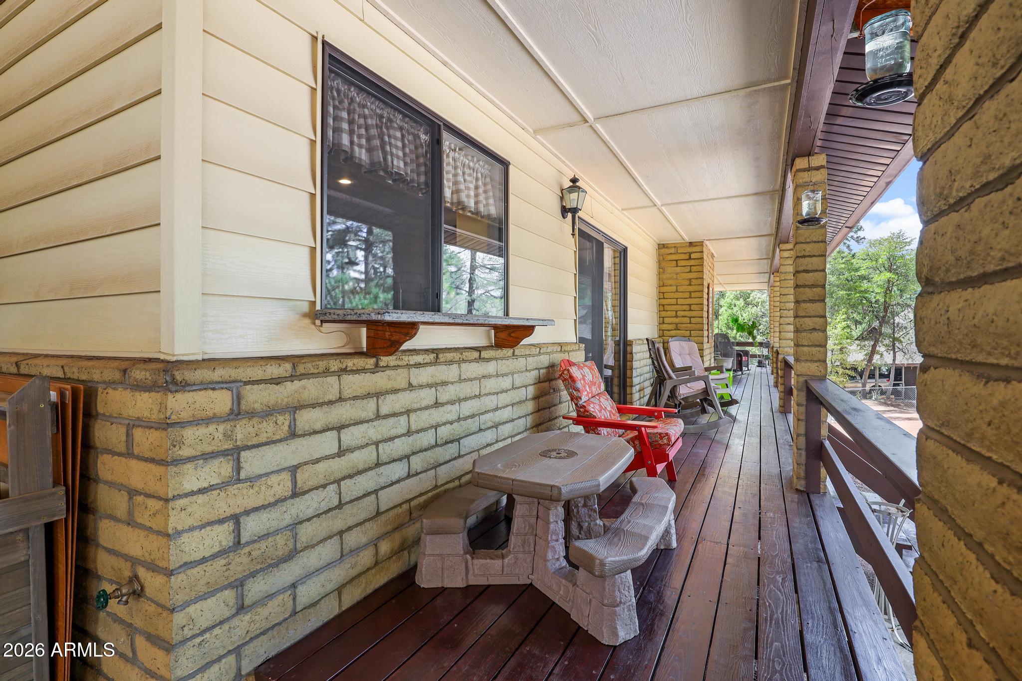 302 West Forest Drive Payson, AZ 85541 - Photo 27 of 39 a balcony with wooden benches and wooden floor