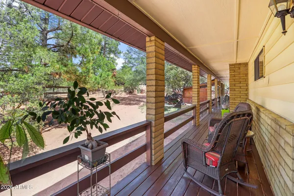 a view of a backyard with a tree and a bench