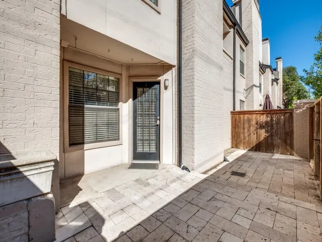 a view of a balcony with wooden floor and iron fence