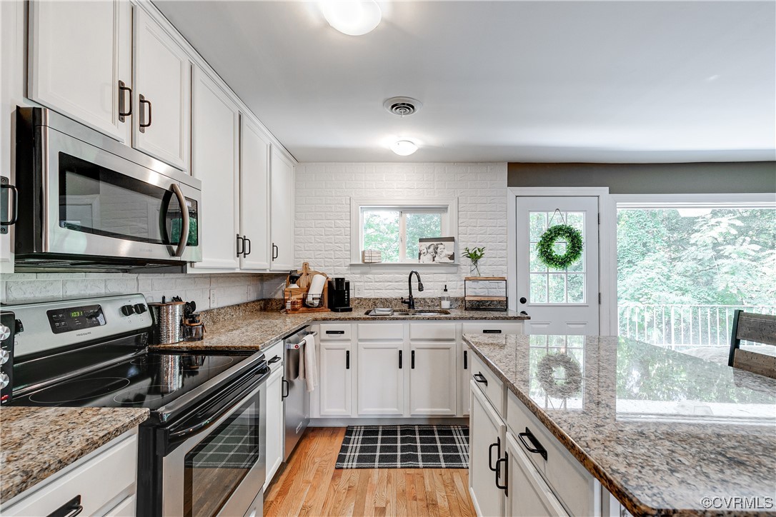6737 Rural Point Road Mechanicsville, VA 23116 - Photo 5 of 32 Kitchen featuring white cabinets, stainless steel