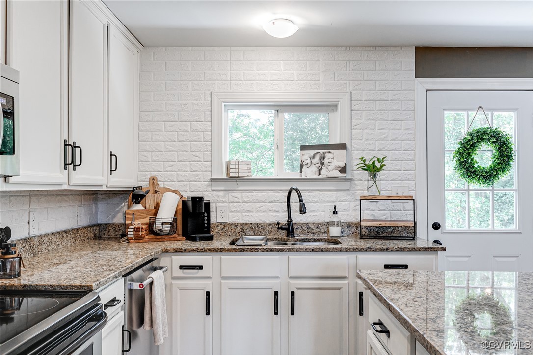 6737 Rural Point Road Mechanicsville, VA 23116 - Photo 9 of 32 Kitchen featuring sink, white cabinets, plenty of