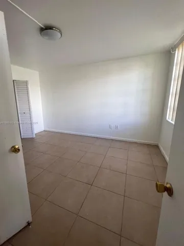 a view of an empty room and a window