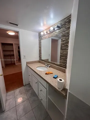 a bathroom with a double vanity sink and mirror
