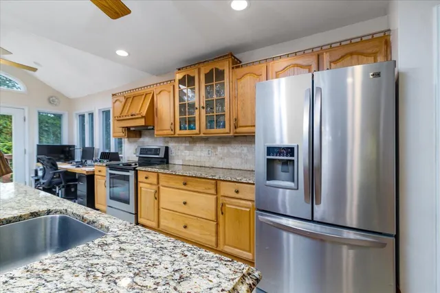 a kitchen with stainless steel appliances granite countertop counter space a sink cabinets and wooden floor